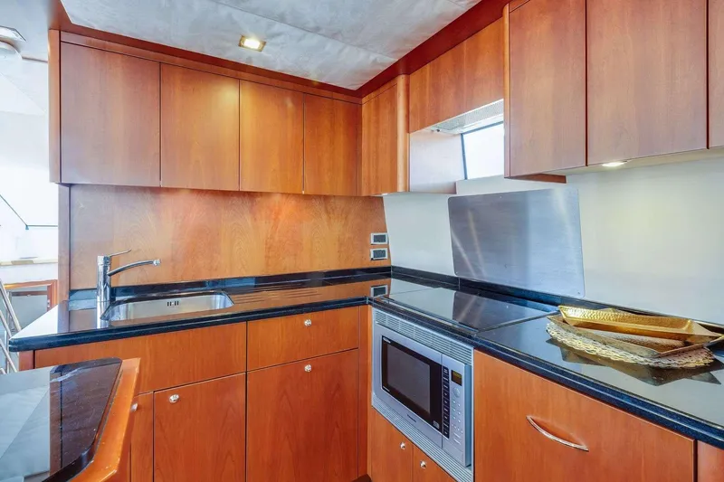 Slide: The Image of Luxurious kitchen interior of 2009 Sunseeker Manhattan 70 yacht with wood cabinetry and modern appliances. - 33