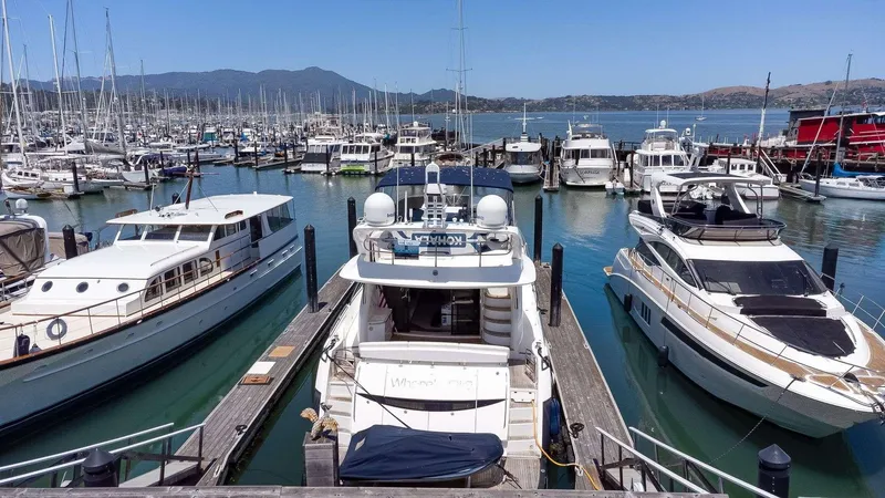 Slide: The Image of Docked yachts at a marina, featuring a 2009 Sunseeker Manhattan 70. - 47