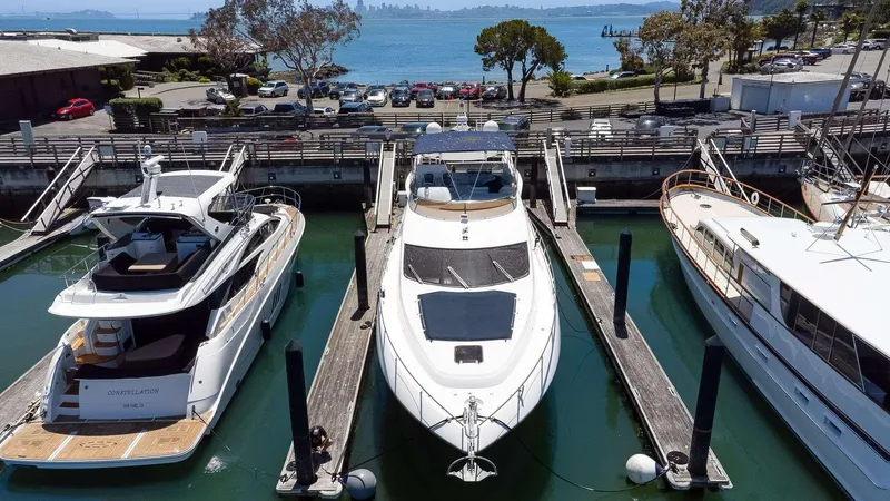 Slide: The Image of 2009 Sunseeker Manhattan 70 yacht docked at marina with scenic ocean view. - 50