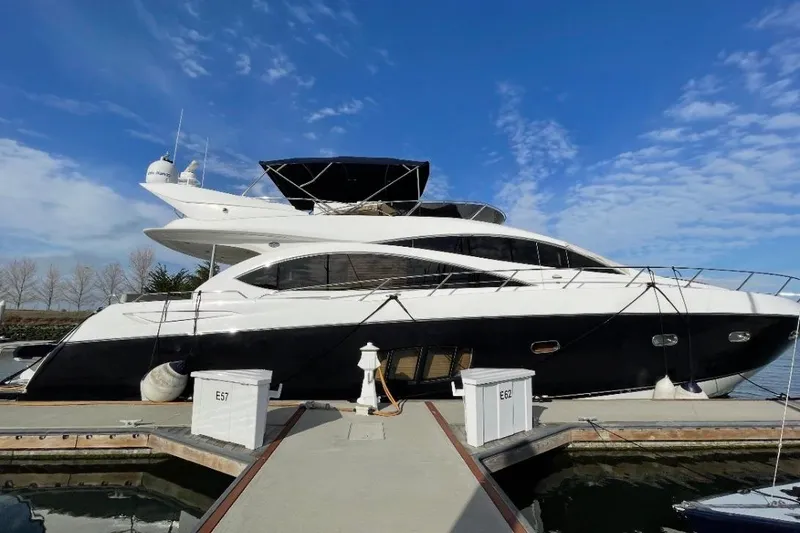 Slide: The Image of 2009 Sunseeker Manhattan 70 yacht docked under a clear blue sky. - 53