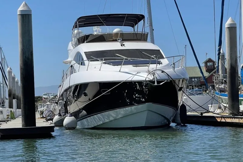 Slide: The Image of 2009 Sunseeker Manhattan 70 yacht docked at marina under clear blue sky. - 54