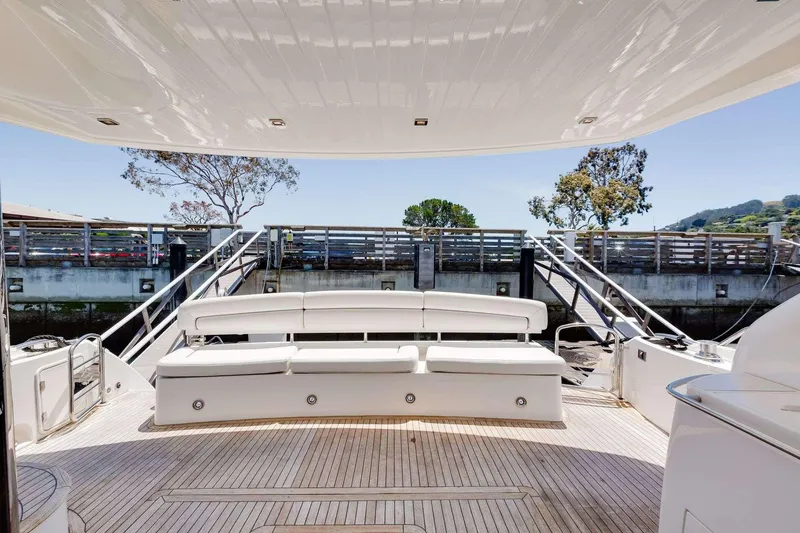 Slide: The Image of Luxurious 2009 Sunseeker Manhattan 70 yacht deck with elegant seating and scenic view. - 7