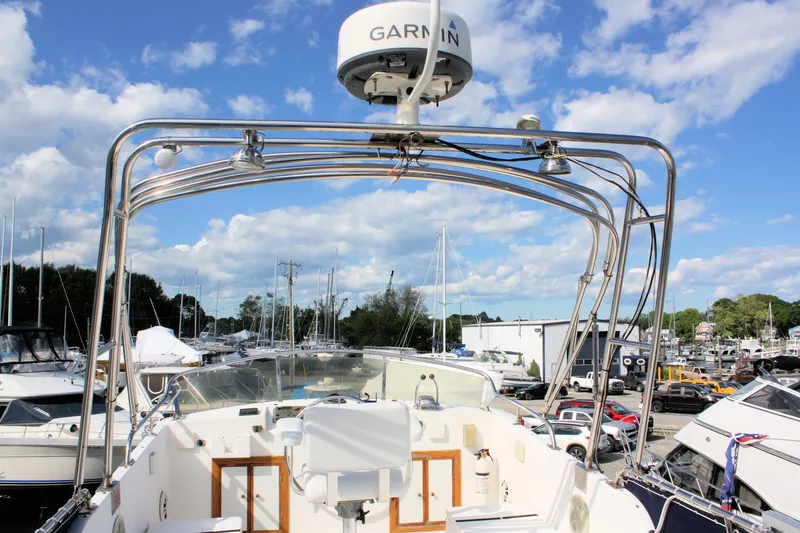 Slide: The Image of Island Gypsy 32 boat, 2000 model, with Garmin radar, docked under a blue sky. - 17