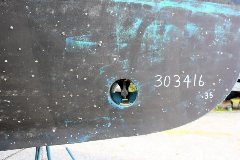 Slide: The Image of Hull of 2000 Island Gypsy 32 boat with visible propeller and identification number. - 24