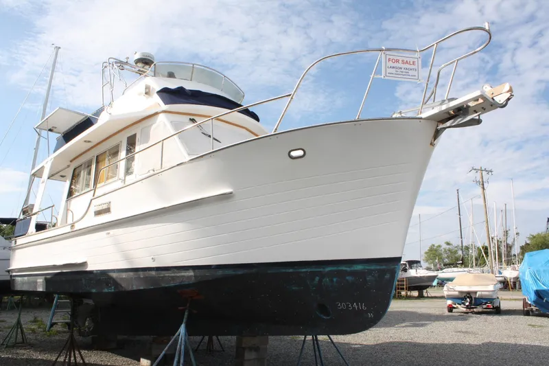Slide: The Image of Island Gypsy 32 yacht from 2000 for sale, displayed on stands in a boatyard. - 3