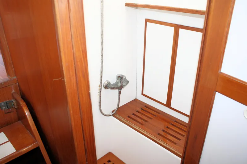 Slide: The Image of Island Gypsy 32 yacht shower area with wooden accents, 2000 model. - 33