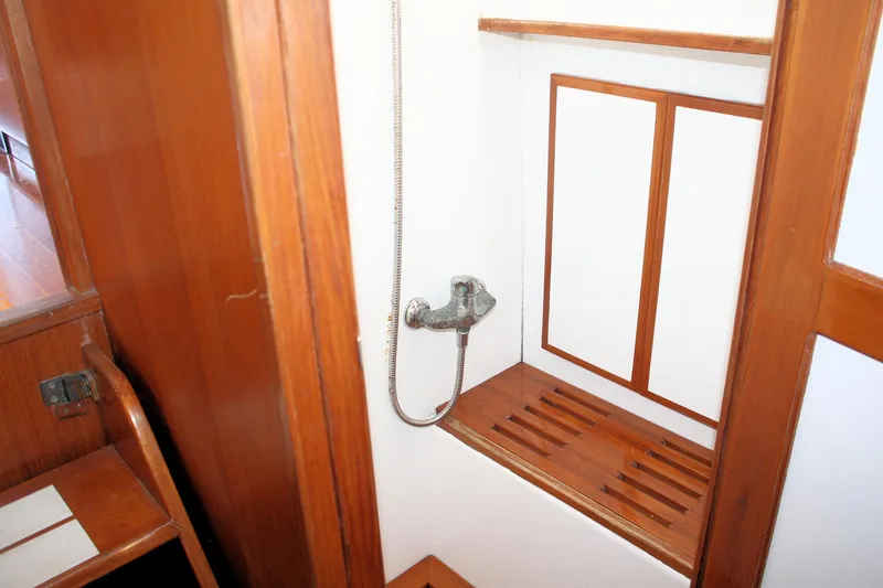Slide: The Image of Island Gypsy 32 yacht shower area with wooden accents, 2000 model. - 34