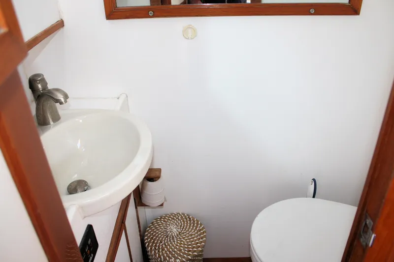 Slide: The Image of Compact bathroom in 2000 Island Gypsy 32 boat with sink and toilet. - 36