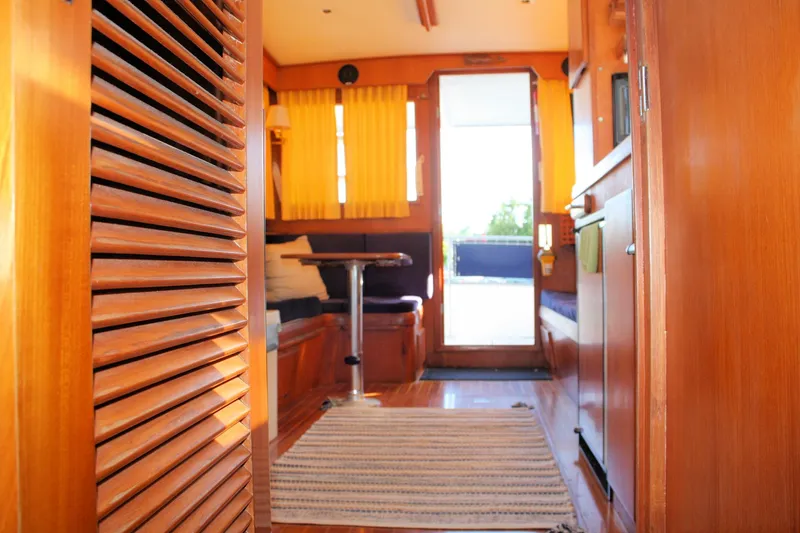 Slide: The Image of Interior of 2000 Island Gypsy 32 boat with wooden furnishings and natural light. - 38