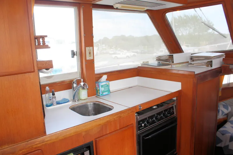 Slide: The Image of Interior of 2000 Island Gypsy 32 boat with kitchen sink and stove. - 43