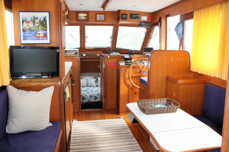 Slide: The Image of Interior of 2000 Island Gypsy 32 boat with cozy seating and nautical decor. - 49