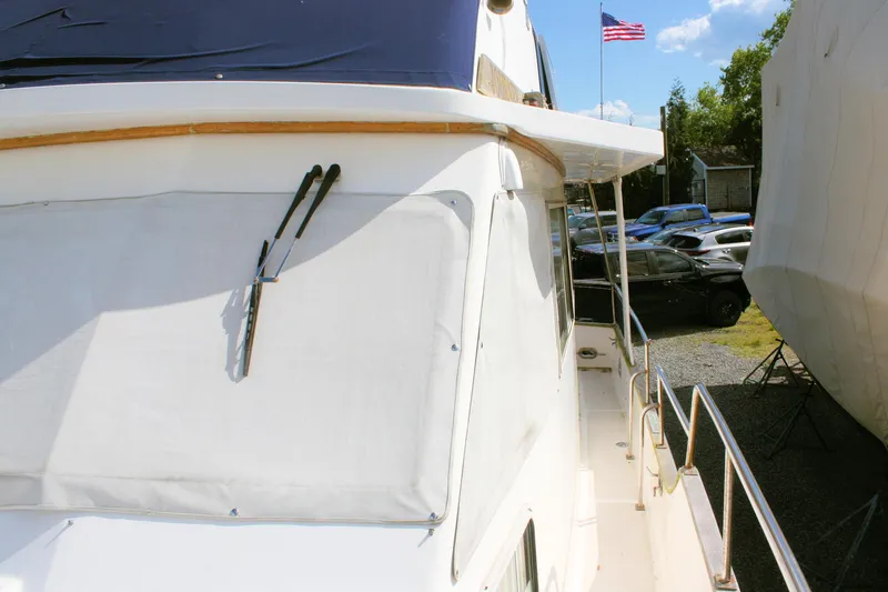 Slide: The Image of Island Gypsy 32 yacht, 2000 model, docked with American flag in background. - 9