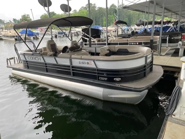 The Image of 2019 Coach Pontoons 230 RF Tritoon docked at a marina. - 1