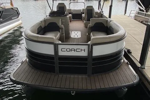 Slide: The Image of 2019 Coach Pontoons 230 RF Tritoon docked, featuring spacious seating and sleek design. - 10