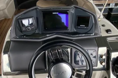 Slide: The Image of Dashboard of 2019 Coach Pontoons 230 RF Tritoon with navigation controls. - 11