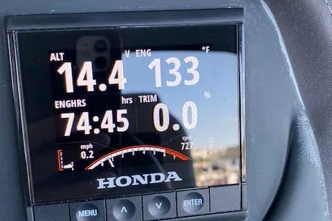Slide: The Image of Dashboard display of a 2019 Coach Pontoons 230 RF Tritoon with Honda engine metrics. - 14