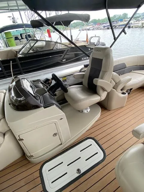 Slide: The Image of 2019 Coach Pontoons 230 RF Tritoon with luxurious seating and sleek dashboard design. - 4