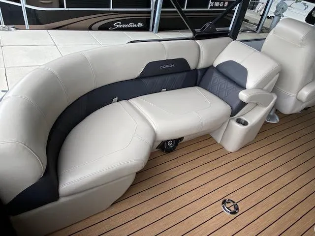 Slide: The Image of 2019 Coach Pontoons 230 RF Tritoon interior with beige and gray seating. - 7