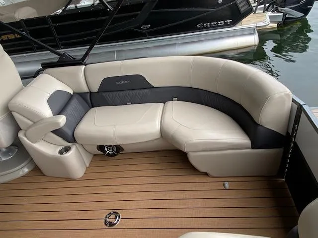 Slide: The Image of 2019 Coach Pontoons 230 RF Tritoon with beige seating and wood deck. - 8