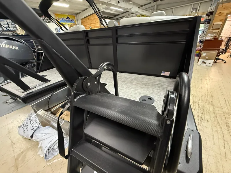 Slide: The Image of 2025 Viaggio V20U boat interior with Yamaha engine, featuring sleek black design and seating area. - 7