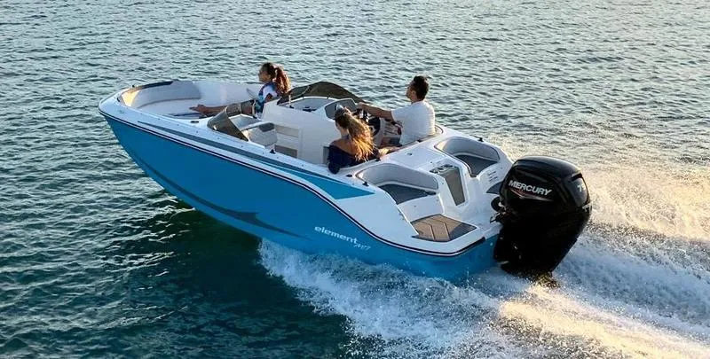 Slide: The Image of 2024 Bayliner M17 boat cruising on open water with passengers enjoying the ride. - 5
