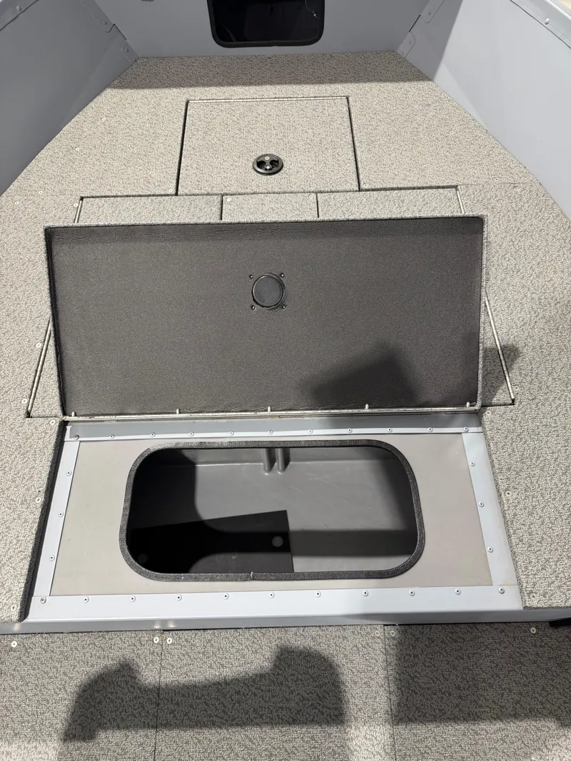 Slide: The Image of 2024 G3 V150T Guide boat with open storage compartment on textured deck. - 10