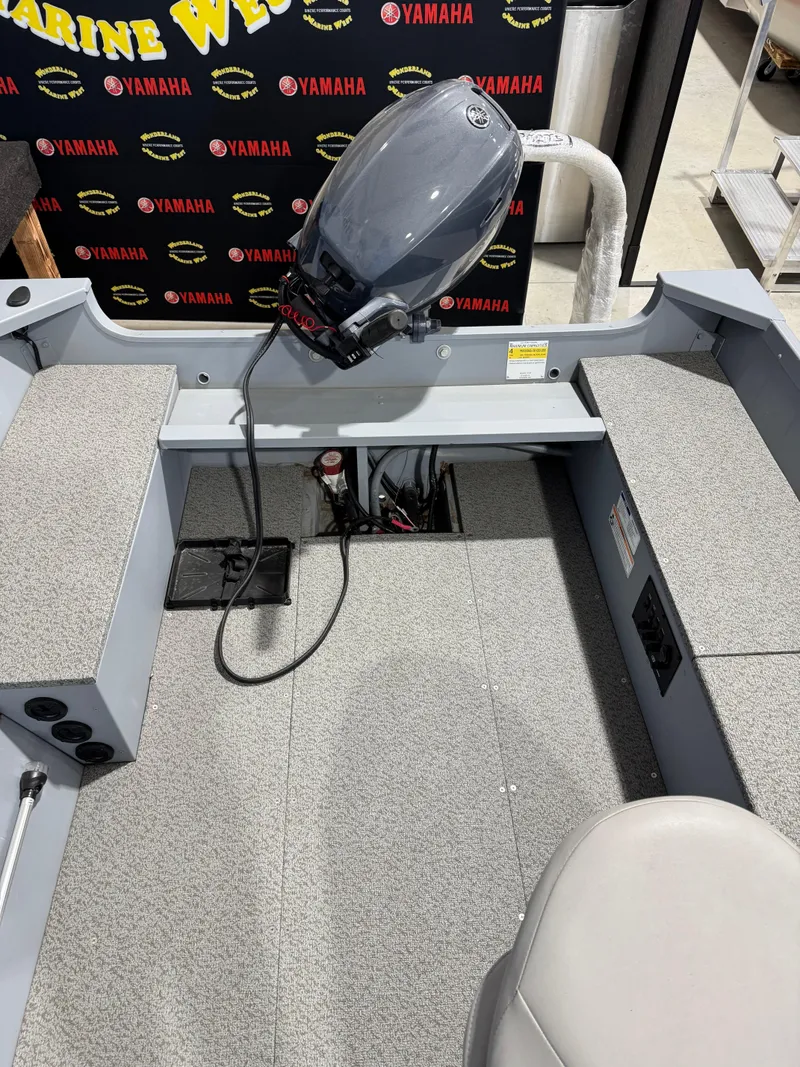 Slide: The Image of 2024 G3 V150T Guide boat interior with Yamaha motor, gray seating, and carpeted flooring. - 8