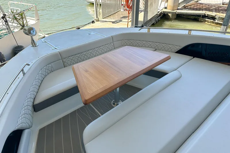 Slide: The Image of Luxurious seating area on 2025 Sea Ray Sundancer 370 yacht with wooden table. - 10