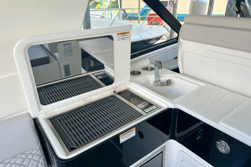 Slide: The Image of 2025 Sea Ray Sundancer 370 yacht interior with grill and sink area. - 11
