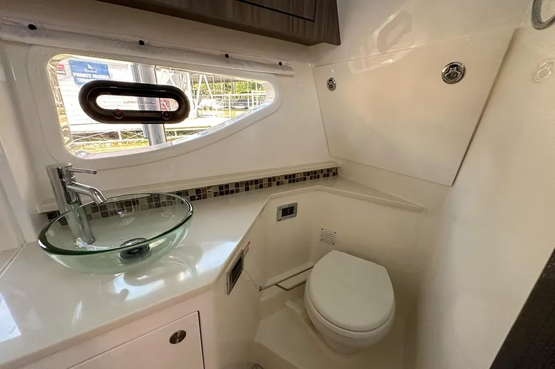 Slide: The Image of Luxurious bathroom in 2025 Sea Ray Sundancer 370 yacht with modern fixtures and glass sink. - 25
