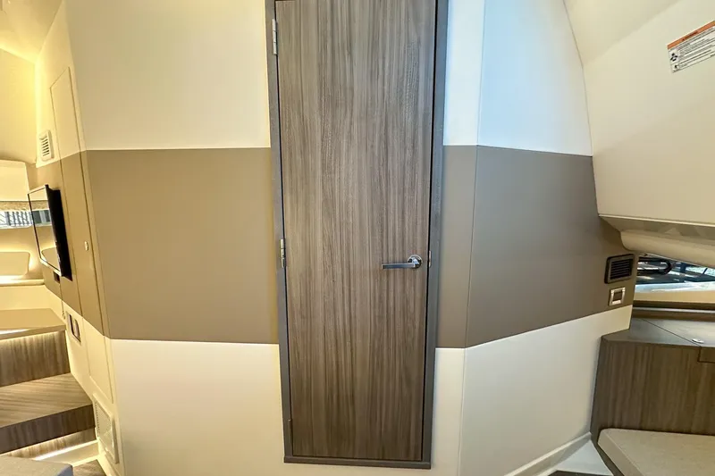Slide: The Image of 2025 Sea Ray Sundancer 370 interior with modern wood door and sleek design elements. - 27