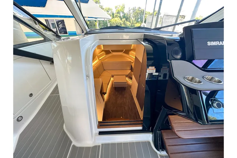 Slide: The Image of 2025 Sea Ray Sundancer 370 cabin interior with modern design and ambient lighting. - 34