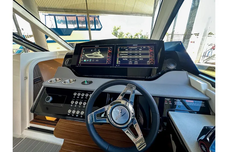 Slide: The Image of 2025 Sea Ray Sundancer 370 helm with advanced navigation displays and controls. - 35