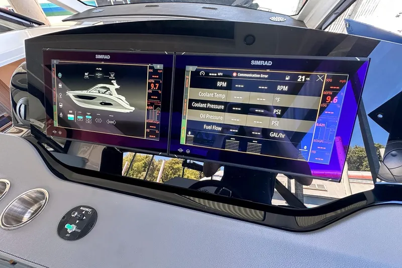 Slide: The Image of 2025 Sea Ray Sundancer 370 dashboard with dual Simrad displays showing navigation and engine data. - 36