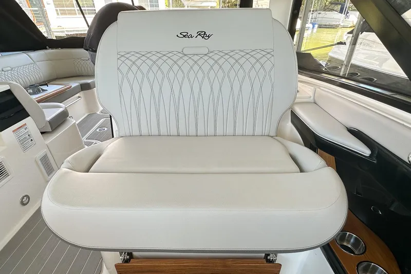Slide: The Image of 2025 Sea Ray Sundancer 370 interior with elegant white seating and modern design. - 39