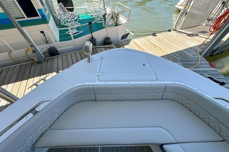 Slide: The Image of Bow view of 2025 Sea Ray Sundancer 370 docked, featuring sleek seating and deck design. - 45