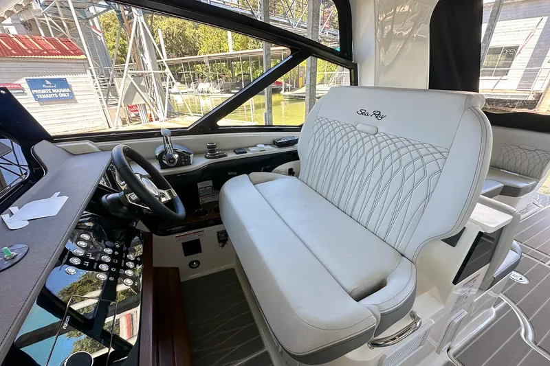 Slide: The Image of 2025 Sea Ray Sundancer 370 helm with luxurious seating and modern controls. - 48