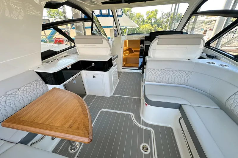 Slide: The Image of Luxurious interior of 2025 Sea Ray Sundancer 370 yacht with elegant seating and wooden table. - 7