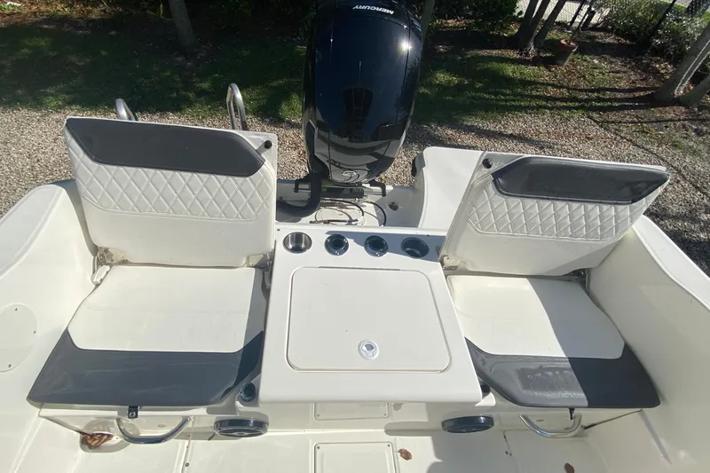 Slide: The Image of 2023 Bayliner Trophy T20CC boat interior with dual seats and Mercury outboard motor. - 9