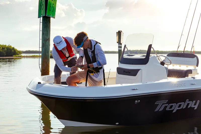 Slide: The Image of 2023 Bayliner Trophy 20CC boat with two people fishing at sunset. - 16