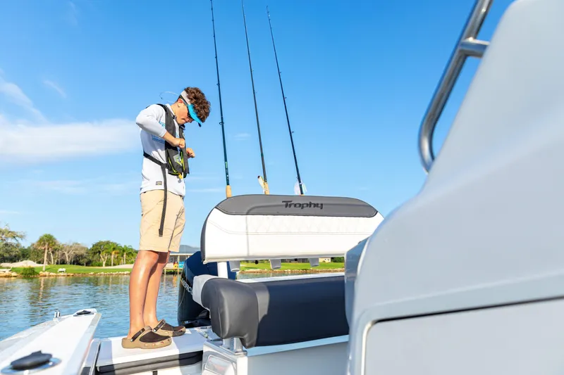 Slide: The Image of Man preparing fishing gear on 2023 Bayliner Trophy 20CC boat. - 18