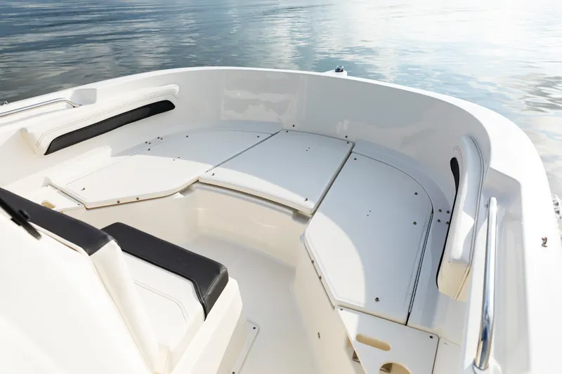 Slide: The Image of 2023 Bayliner Trophy 20CC boat interior with seating, on calm water. - 19