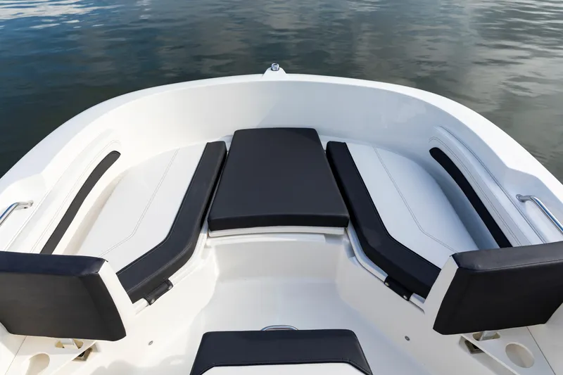 Slide: The Image of 2023 Bayliner Trophy 20CC boat interior with cushioned seating and sleek design. - 22