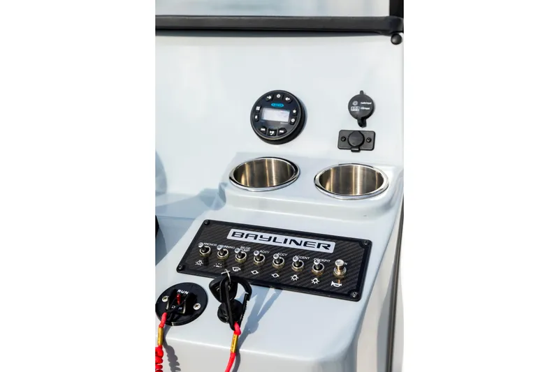 Slide: The Image of 2023 Bayliner Trophy 20CC console with controls, cup holders, and switches. - 29