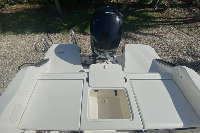 Slide: The Image of 2023 Bayliner Trophy T20CC boat with Mercury engine, featuring spacious deck and storage compartments. - 8
