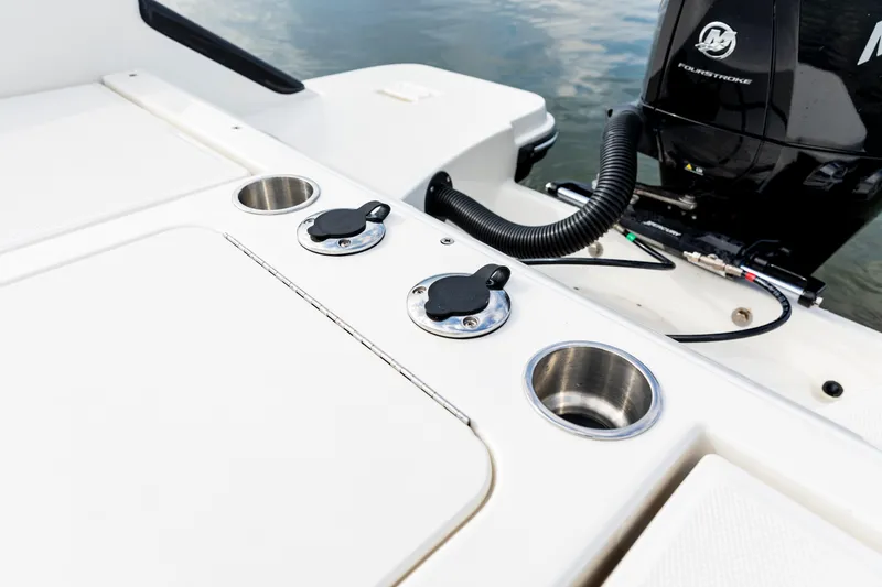 Slide: The Image of 2023 Bayliner Trophy 20CC boat deck with cup holders and engine detail. - 34