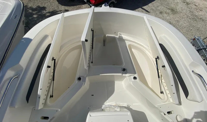 Slide: The Image of 2023 Bayliner Trophy 20CC boat with two people fishing on calm water. - 5