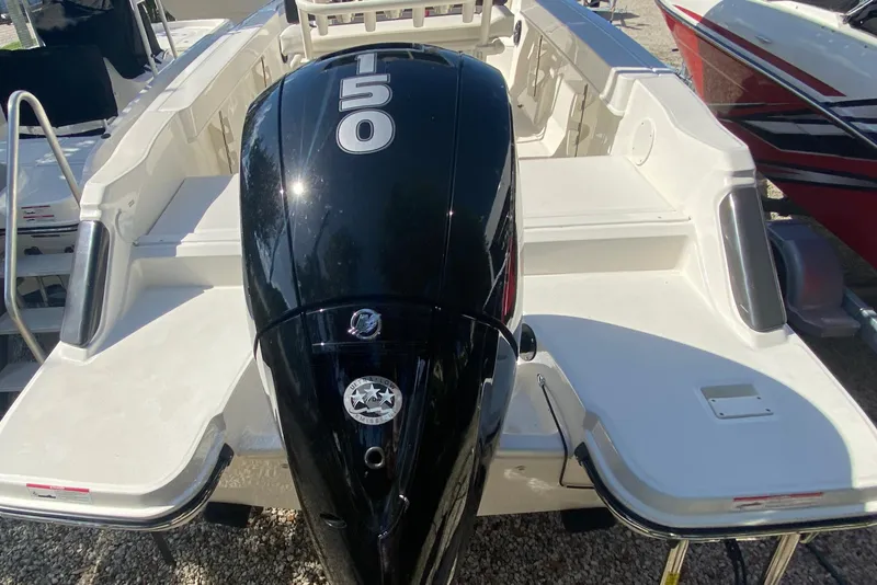 Slide: The Image of 2023 Bayliner Trophy T20CC boat with powerful 150 HP outboard motor, rear view. - 11