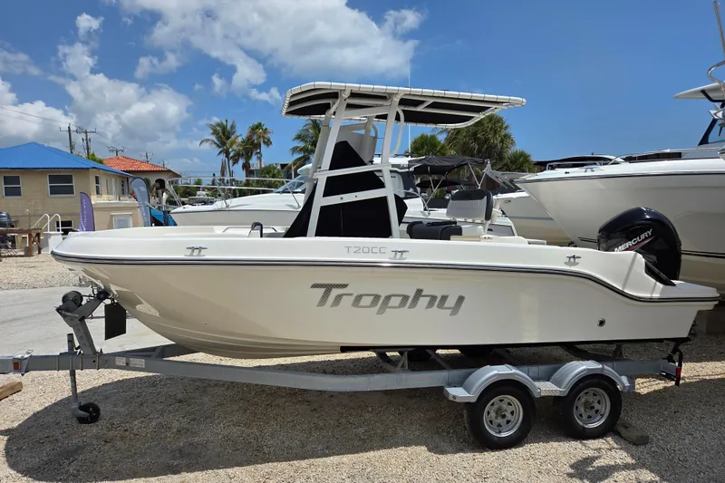 The Image of 2023 Bayliner Trophy T20CC boat on trailer under clear blue sky. - 1