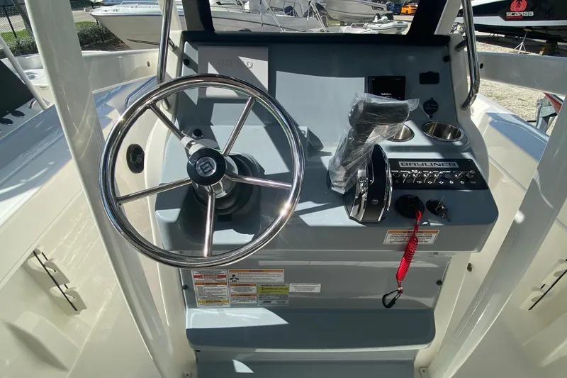 Slide: The Image of 2023 Bayliner Trophy T20CC boat console with steering wheel and control panel. - 6